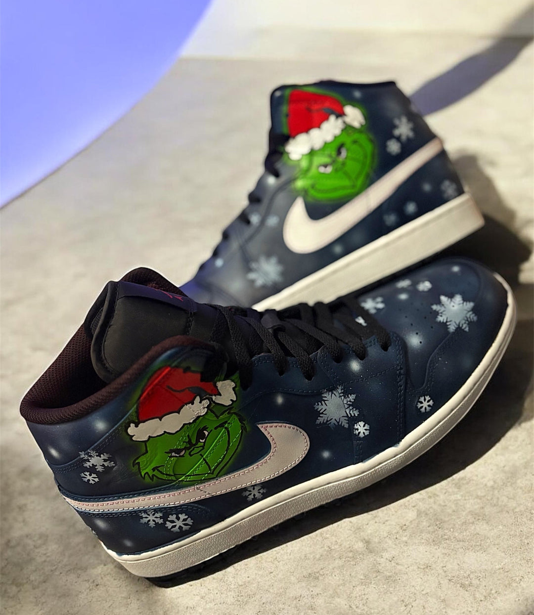 Custom air Jordan 1 mids Christmas themed edition. Grinch face design with snow flurries 