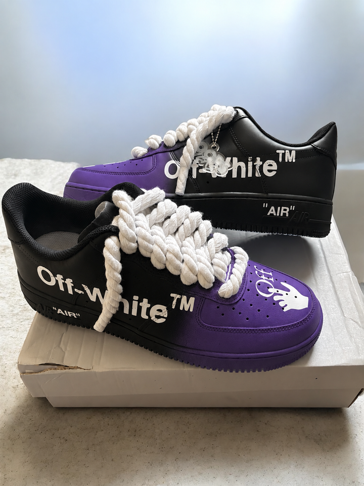 A pair of Off-White Air Force 1 style sneakers in black and purple, featuring chunky white laces and white printed branding