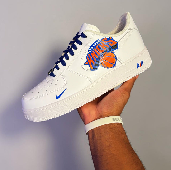 Custom white AF1s with blue and orange Knicks logo and colored Nike swoosh 