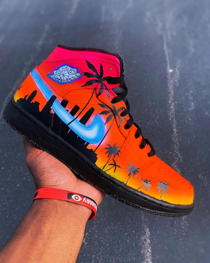 Custom Air Jordan 1s with a sunset color fade and palm tree design 