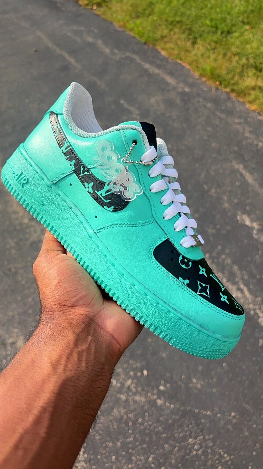 customized mint green and black sneaker with white laces, featuring a Louis Vuitton monogram pattern on the toe box