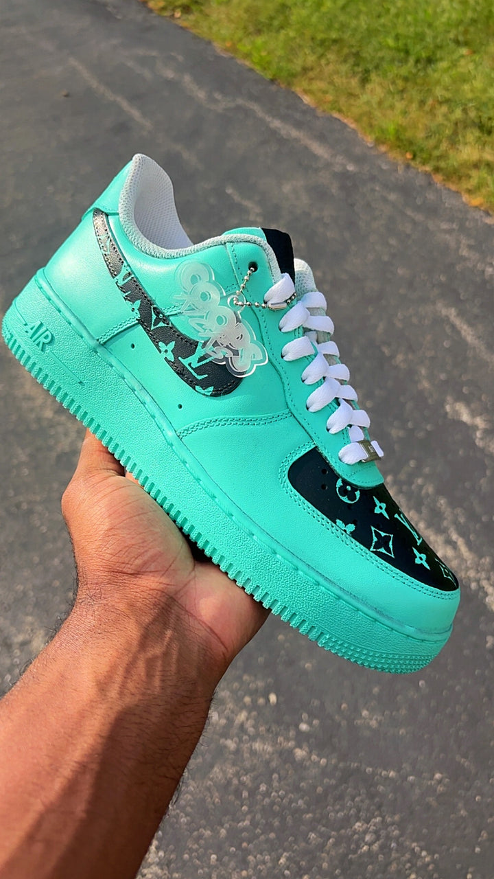 customized mint green and black sneaker with white laces, featuring a Louis Vuitton monogram pattern on the toe box